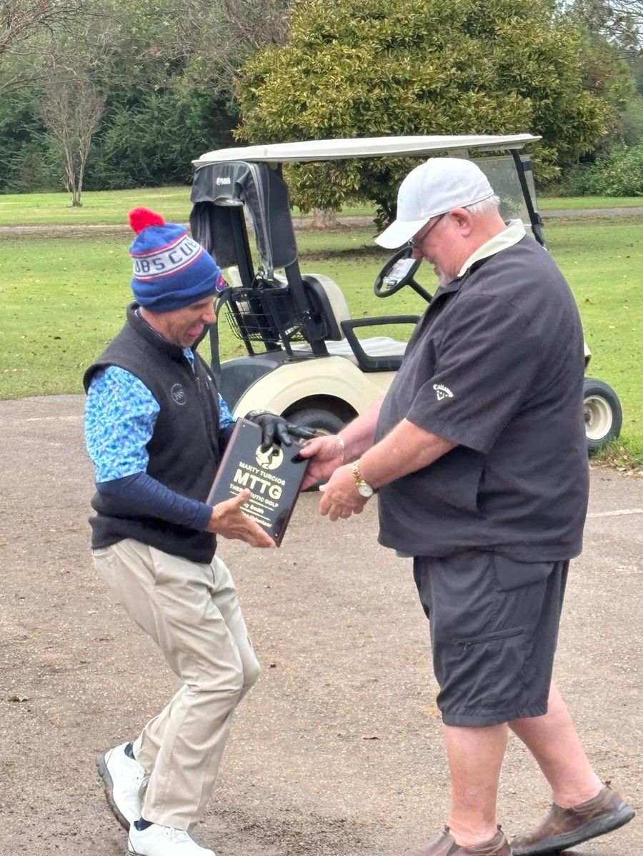 Marty Turcios presenting the MTTG Outstanding Volunteer Award plaque to Ricky Smith