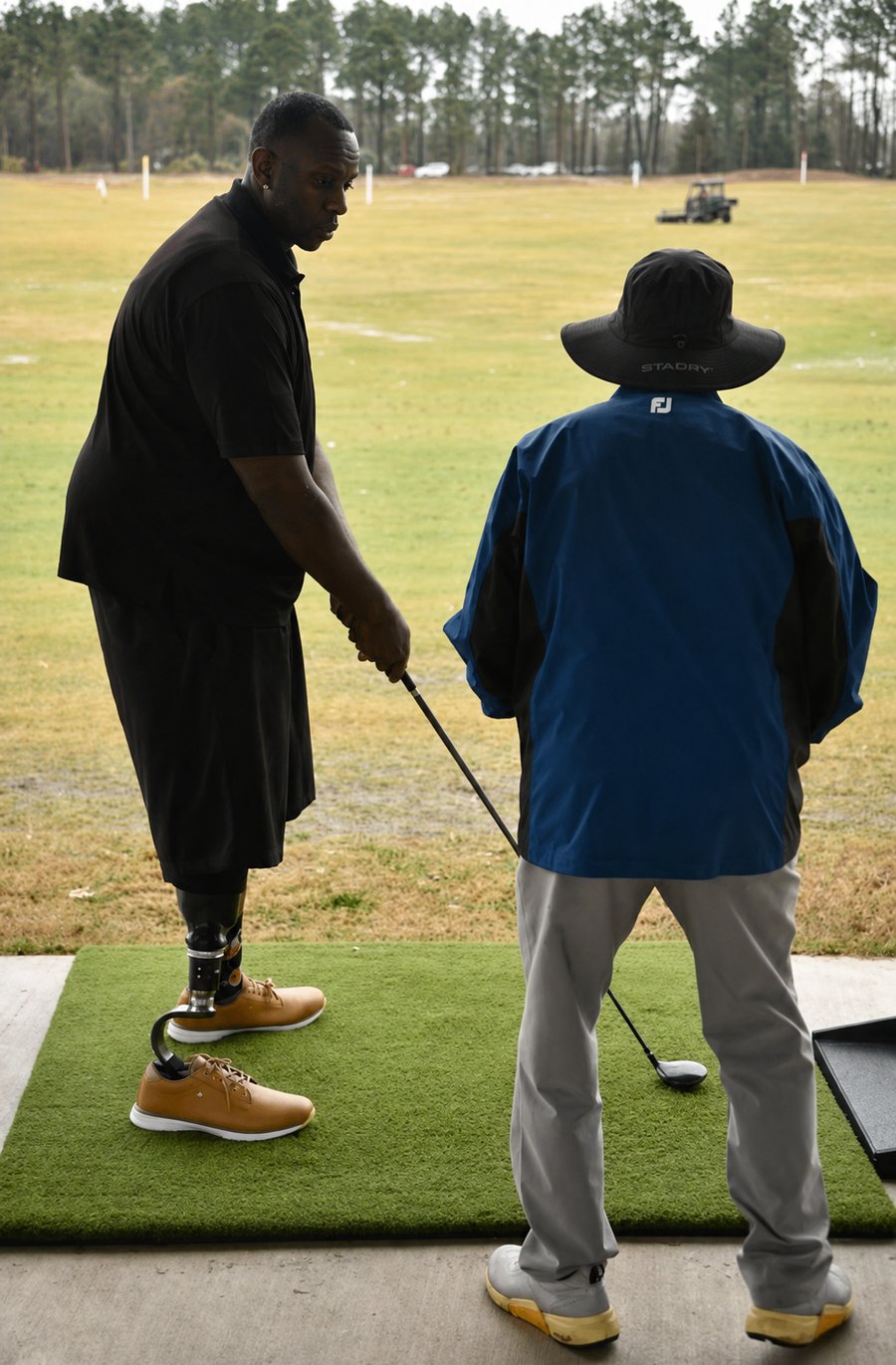 An MTTG instructor working one-on-one with a participant at the driving range